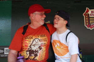 A man and boy standing next to each other.