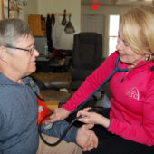 A woman is taking care of an older person.
