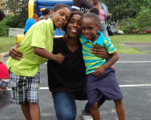 A woman and two boys posing for the camera.