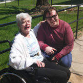 A woman and an older person in a wheelchair.