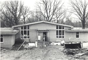 A black and white photo of a building being built.
