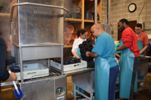 A group of people in a kitchen preparing food.