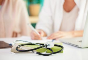 A stethoscope is laying on top of a book.