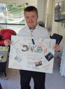 A young man shows off a vision board he created