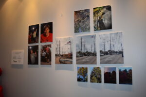 Photographs hang on a wall in an exhibit.